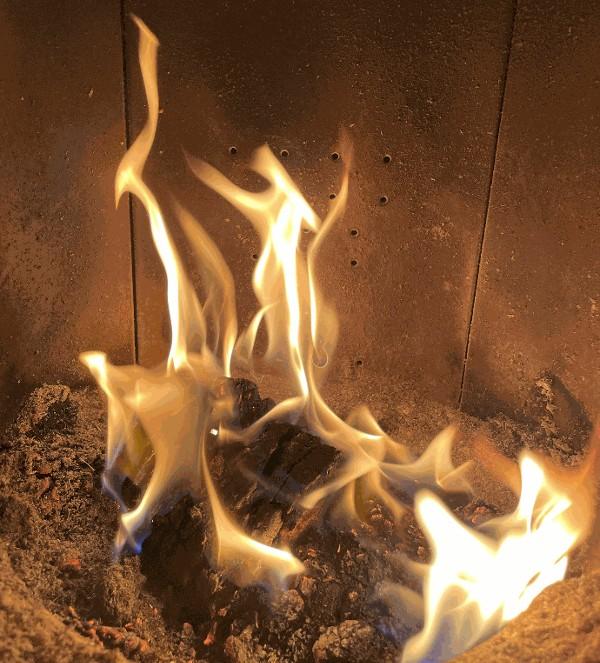 demie buche compressée en flamme dans un poele a bois