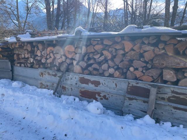 Buches de bois et rangées en extérieur avec une tolle metallique