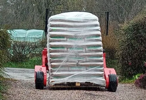 Livraison de granulés à domicile avec un transpalette tout terrain